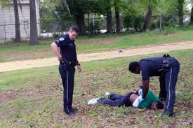 Walter Scott lays dead as Officer Slager checks for a pulse after shooting the 50-year old man in the back 5 times and lying on his police radio about what transpired.