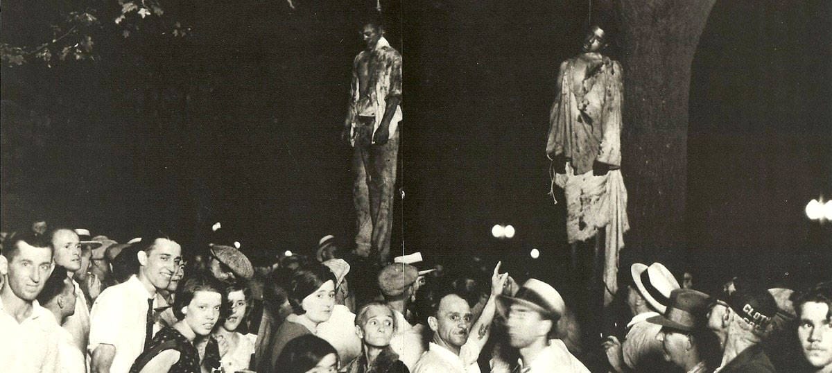 Photo of lynching showing the hanged bodies of two black men and a mixed crowd of white onlookers