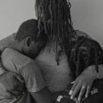 Photo of huddling family