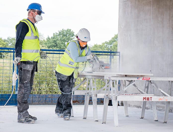 Husband and wife volunteers working on drywall installation