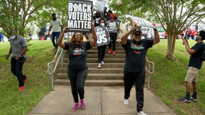 People with 'black voters matter' signs