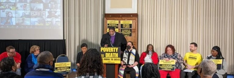 Photo of Dr. William Barber speaking at podium